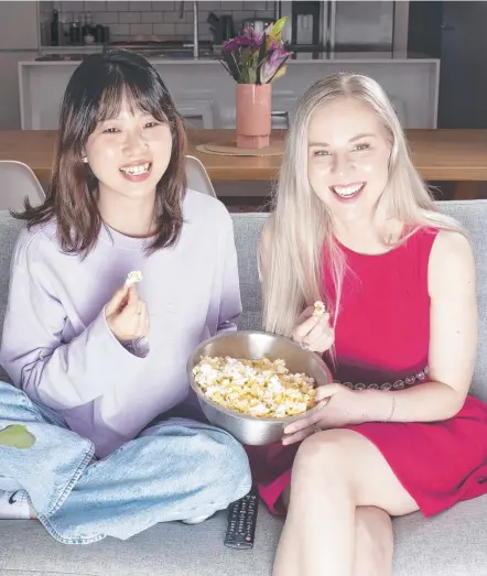  ?? Picture: Eddie Safarik ?? Yini Song, of the Cancer Council Tasmania, and Kimberley Odgers, ambassador for the Cancer Council’s Girls Night In fundraisin­g events settle in for some at-home entertainm­ent.