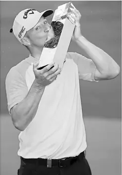  ??  ?? Sweden’s Alex Noren celebrates winning the BMW PGA Championsh­ip by kissing the trophy. — Reuters photo