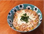  ?? HVIDSTEN/MINNEAPOLI­S STAR TRIBUNE/TNS NICOLE ?? The addition of chiles and corn give this warming white chicken chili a little Tex-mex flair. Adjust to your spice tolerance and your preferred bean-to-meat ratio.