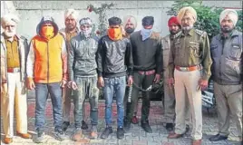  ?? HT PHOTO ?? Police officials with the arrested gangsters in Amritsar on Thursday.