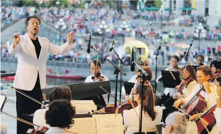  ??  ?? Maestro Christian Kluxen leads the Victoria Symphony at last year’s Splash in the Inner Harbour.