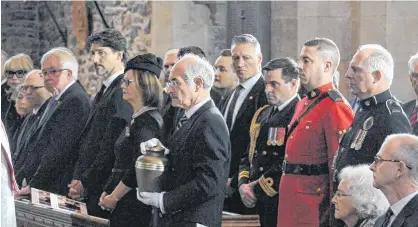  ?? JOE GIBBONS/THE TELEGRAM ?? Funeral director Geoff Carnell carries Urn with the remains of John Crosbie at Thursday afternoon’s funeral service. At lower right is Crosbie’s widow Jane and their son Ches Crosbie. At left and to the right of Carnell is Her Honour, Judy Foote, NL Lieutenant Governor, Prime Minister Justin Trudeau and former Prime Minister Joe Clark and Senator George Furey.