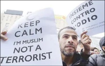  ?? REUTERS ?? A man holds a placard during a rally called ‘Not in my name’ of Italian Muslims against terrorism in Milan Saturday.