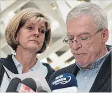  ?? JACQUES BOISSINOT THE CANADIAN PRESS ?? Manon Marchand looks on as husband Raymond Bissonnett­e, right, reads a statement on Thursday at the hall of justice in Quebec City.