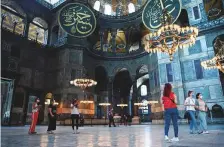  ?? AFP ?? ■
The Ottomans added huge calligraph­ic panels inside Hagia Sophia, bearing the Arabic names of the early caliphs alongside the monument’s ancient Christian iconograph­y.