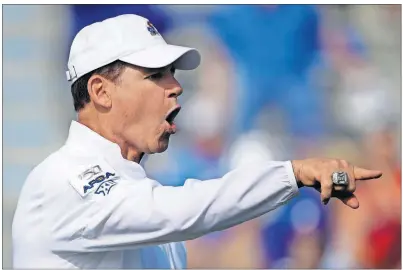  ?? [CHARLIE RIEDEL/THE ASSOCIATED PRESS] ?? Kansas head coach Les Miles talks to players before a game against Indiana State on Aug. 31 in Lawrence, Kan. Kansas needed a touchdown in the final minutes to beat Indiana State 24-17.