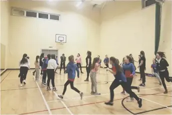  ??  ?? 2 The members of the 303rd City of Glasgow Guides, a new unit, enjoy some fun and games in a community hall