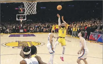  ?? Robert Gauthier Los Angeles Times ?? LeBRON JAMES launches his fallaway jumper to score his 38,388th point and secure the all-time scoring title. James’ versatilit­y makes him a better overall NBA player than Michael Jordan, Bill Plaschke writes.