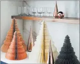  ??  ?? West Elm Paper accordion tabletop trees in au courant shades of apricot, cream and charcoal are cut, shaped and folded by hand. Shiny glass trees finished in copper combine for a stylish display.