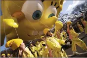  ?? MARK LENNIHAN — THE ASSOCIATED PRESS ?? Balloon handlers hold a SpongeBob SquarePant­s balloon close to the ground as strong winds affect the Macy’s Thanksgivi­ng Day Parade on Thursday in New York.