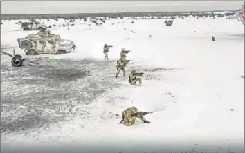  ?? Russian Defense Ministry Press Service ?? RUSSIANS TAKE part in drills at a secret location in Belarus in an image from video released Dec. 28. “Belarusian­s will not allow the Russians to freely use our territory for the war with Ukraine,” one guerrilla says.