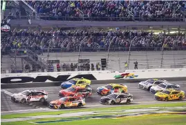  ?? PHELAN M. EBENHACK/ASSOCIATED PRESS ?? Austin Cindric (2) takes the checkered flag in front of Bubba Wallace (23) at last year’s Daytona 500. This 75th NASCAR season will be more focused on future than past.