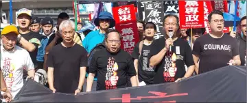  ?? — AFP photo ?? Protesters hold a banner which reads ‘March For Democracy in China’ as they take part in a march in Hong Kong to commemorat­e the June 4, 1989 Tiananmen Square crackdown in Beijing in this file photo.