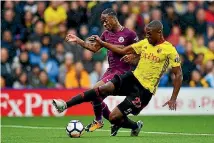  ??  ?? Raheem Sterling of Manchester City and Christian Kabasele of Watford contest the ball. Sterling scored City’s final goal in a 6-0 rout.