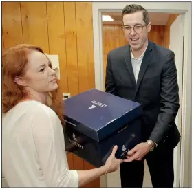  ?? Arkansas Democrat-Gazette/JOHN SYKES JR. ?? Ben Elder, an attorney for Cherokee Nations Businesses of Oklahoma, hands Arkansas Racing Commission executive assistant Nikki Langston a box of documents Thursday in Little Rock as he and another attorney filed the group’s new applicatio­n for a casino license in Pope County.