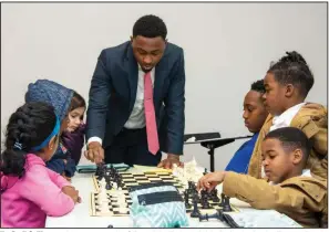  ?? (Arkansas Democrat-Gazette/Cary Jenkins) ?? KenDrell Collins, a trial attorney at the Office of the Federal Public Defender for the Eastern District of Arkansas, coaches young chess enthusiast­s during a weekly meeting of the CPR Chess Club.