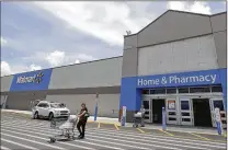  ?? ALAN DIAZ / ASSOCIATED PRESS ?? Walmart plans to add 1,000 online grocery locations, which help fill orders from customers buying their food on Walmart.com. The company expects to reach U.S. online revenue of $11.5 billion this year.