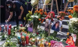  ?? Photograph: David McNew/EPA ?? A mourner places a candle during a memorial ceremony held by loved ones of mostly Latino essential workers who are among the more than 5,700 Angelinos who have been killed by Covid in Los Angeles, California, on 31 August 2020.