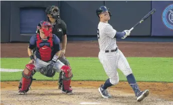  ?? GETTY IMAGES ?? The Yankees’ Aaron Judge smacks the first of his two home runs Sunday against the Red Sox.