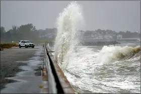  ?? AP/The Virginian-Pilot/JONATHON GRUENKE ?? Waves crash ashore Friday near a police vehicle at Fort Monroe, Va., as Hurricane Dorian moves up the coast. More than 350,000 people were without electricit­y in the Carolinas and Virginia because of the storm.