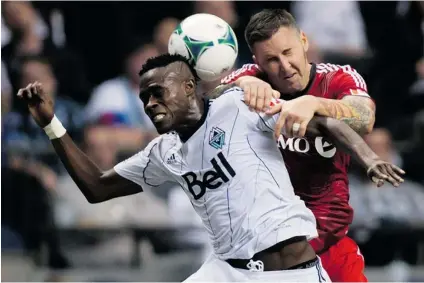  ?? DARRYL DYCK/ THE CANADIAN PRESS FILES ?? Vancouver Whitecaps’ Gershon Koffie, left, and Toronto FC’s Danny Califf vie for the ball. Koffie has been a reserve player for the last two Caps games but he isn’t bitter, saying ‘ whatever doesn’t kill you, makes you stronger, so I’ll be stronger...