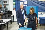  ?? AMIR LEVY / GETTY IMAGES ?? Benny Gantz, head of Blue and White Party, and his wife Revital, cast their votes on Tuesday in Rosh Haayin, Israel.