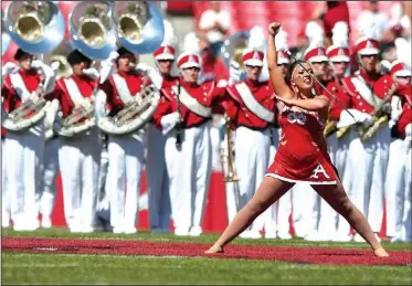  ?? NWA Democrat-Gazette/J.T. WAMPLER ?? Savannah Miller, University of Arkansas twirler, performs Saturday during the Razorbacks football game against Eastern Illinois. Miller earned the silver medal at the 34th World Baton and Twirling Championsh­ips.