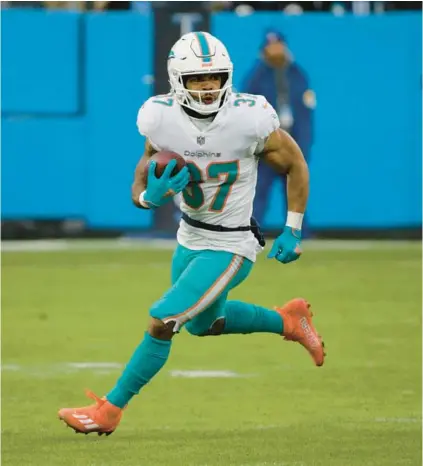  ?? JAMES KENNEY/AP ?? Dolphins running back Myles Gaskin gains yards against the Titans on Jan. 2 in Nashville, Tennessee.