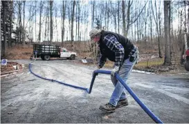  ?? Spencer Platt / Getty Images file ?? Ray Kemble delivers fresh water to a house with contaminat­ed water in Dimock, Pa. Houston-based Cabot Oil & Gas Corp. is suing Kemble, accusing him and his attorneys of trying to extort the company through a frivolous lawsuit.