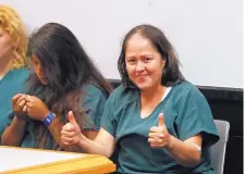  ?? JOHN BAZEMORE/ASSOCIATED PRESS ?? Isabel Martinez gives a thumbs-up to courtroom photograph­ers during her court appearance Friday. She is charged with killing four of her children and her husband.