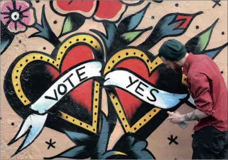  ?? Picture: REUTERS ?? CHURCH SUPPORT: A graffiti artist finishes a Yes campaign piece in Dublin ahead of today’s referendum. A growing minority of priests and nuns are speaking out in favour of equal marriage rights.
