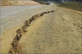  ?? (AP/Renagi Ravu) ?? A large crack is seen in a highway on Sunday near the town of Kainantu, following a 7.6-magnitude earthquake in northeaste­rn Papua New Guinea.