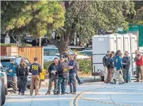  ?? APU GOMES AFP/GETTY IMAGES ?? FBI agents continue to work Friday at the scene of the shooting.