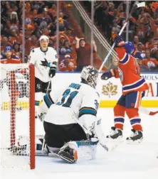  ?? Jeff McIntosh / Associated Press ?? David Desharnais celebrates after slipping a shot past Sharks goalie Martin Jones in overtime to give the Oilers a 4-3 victory.