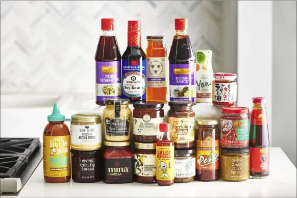  ?? CHEYENNE COHEN ?? To give your recipe repertoire a boost, pick up a few new condiments such as oyster sauce, Sriracha sauce, and a some fun preserves.