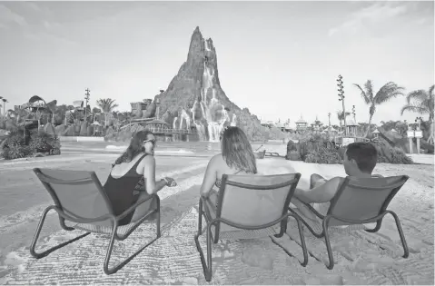  ?? PHOTOS BY UNIVERSAL ORLANDO RESORT ?? At 200 feet, Universal’s Krakatau Volcano towers over its competitor­s and is an imposing sight. Waterfalls cascade down the mountain and feed the Waturi Beach wave pool at the base of the volcano.