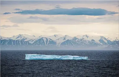  ?? DAVID GOLDMAN THE ASSOCIATED PRESS ?? An iceberg floats past Bylot Island in the Canadian Arctic archipelag­o last summer.