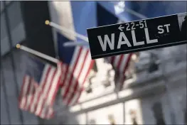  ?? MARK LENNIHAN — THE ASSOCIATED PRESS FILE ?? A sign for Wall Street hangs in front of the New York Stock Exchange.