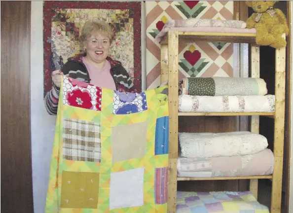  ?? SUPPLIED ?? Sheila Ethier, pictured here in 2004, holds up the quilt her grandmothe­r made for her. The quilt inspired Ethier to found Blankets for Love Foundation for Mental Health in 1996. Helping others and working on the foundation helps Ethier with her own...
