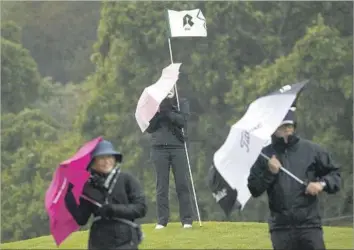  ?? Patrick T. Fallon For The Times ?? COURSE MARSHALS had a difficult time at the Genesis Open on Friday, with rain and wind finally forcing play to be halted at 12:18. Officials hope to be able to finish the second round by 2 p.m. today.