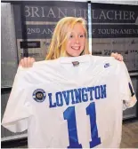  ??  ?? Lily Edgeington holds an autographe­d jersey.