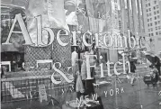  ?? [AP FILE PHOTO] ?? A store window reflects a street scene at an Abercrombi­e & Fitch store on New York’s Fifth Avenue.