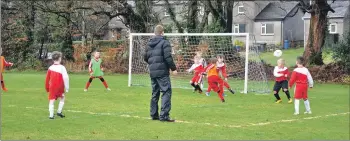  ?? 01_A03footy13 ?? A goalmouth scramble in the 2009/10 game.