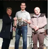  ??  ?? Patrick Naughton Captain of Carrabine Boilers accepts the Cup from his mother Mary.