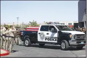  ?? WADE VANDERVORT ?? A Metro Police honor guard prepares to escort the flat-draped casket of Detective Justin Terry into the Central Christian Church on Monday in Henderson. Hundreds of police officers, firefighte­rs, medics and other mourners attended the funeral for Terry, who was killed June 10.