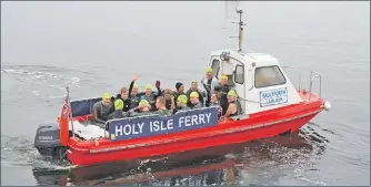  ?? 01_B38splash0­3 ?? Swimmers are transporte­d to the start of the race on the Holy Isle ferry.