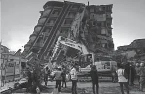  ?? KHALIL HAMRA/AP ?? Rescuers search in the rubble of destroyed buildings Thursday in Antakya, southern Turkey. Turkey has for years tempted fate by not enforcing modern constructi­on codes, experts say.