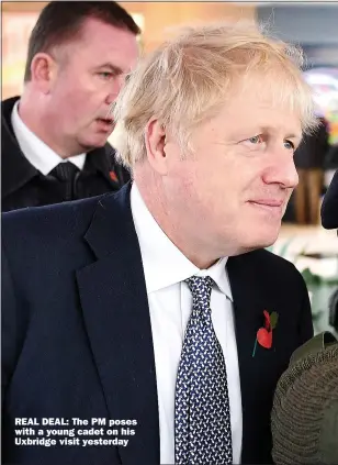  ??  ?? REAL DEAL: The PM poses with a young cadet on his Uxbridge visit yesterday