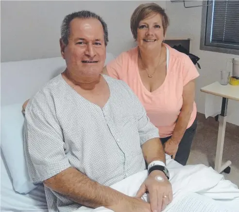  ??  ?? GRATEFUL: King Island resident Tony Frosh with wife Colleen O'Flaherty in Cairns Hospital’s cardiac ward. Mr Frosh suffered a heart attack while holidaying in Cairns and underwent two operations. Picture: DANIEL BATEMAN