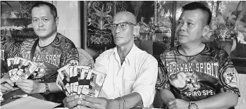  ??  ?? Peter (centre), flanked by Tan Kok Chiang (right) and KTHSS president Chan Chee Hiong, shows the entry ticket for the forum.